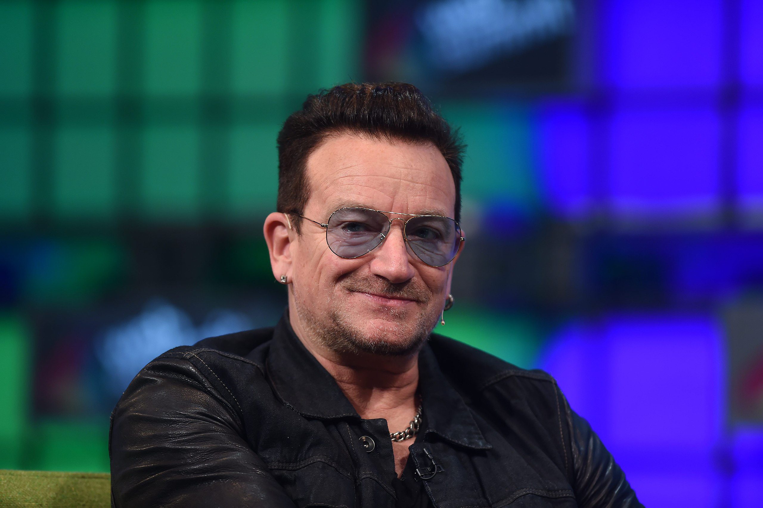photo of U2 bono in black shirt wearing sunglasses