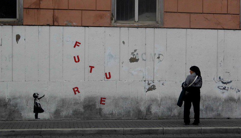 Photo of a wall with graffiti and FUTURE in red letters