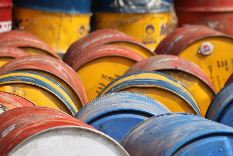 group of red, yellow, blue and white oil drums