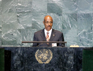 Photo of Seyoum Mesfin at podium dressed in dark suit.