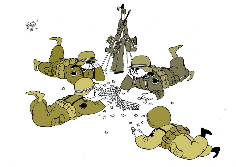 Soldiers with guns stacked behind them, on the ground putting a puzzle together.
