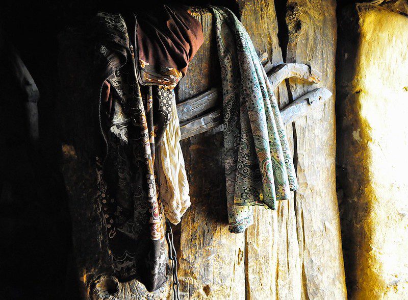 photo of colorful clothes over a wooden door