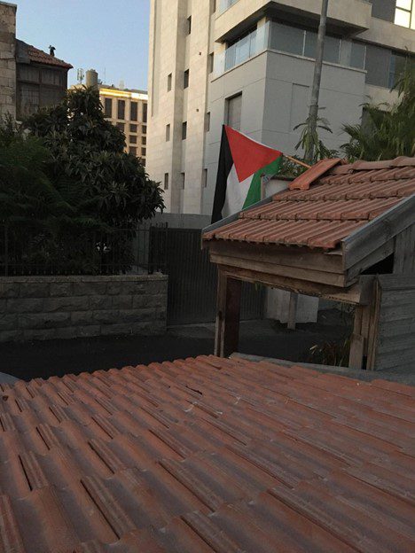 Rooftop of Palestinian home, with flag