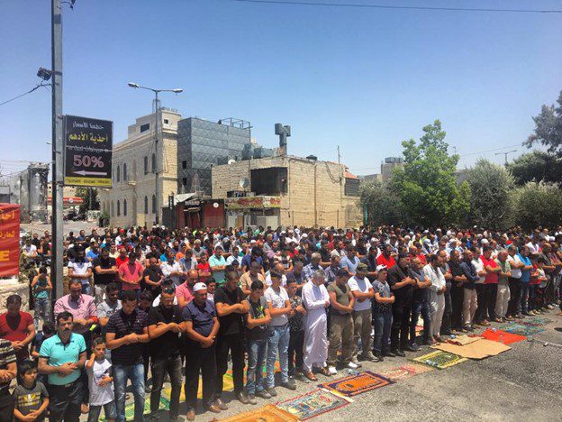 large group of people peacefully protesting in street