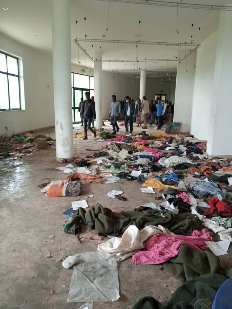 Hallway with clothing of prisoners held at the museum strewn across the floor.