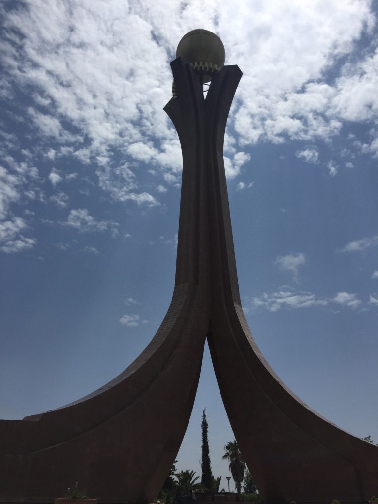 The memorial: Stone arcs curve to the sky, topped by a ball.