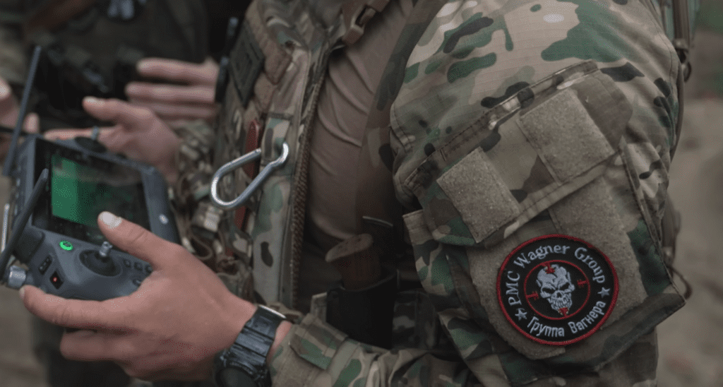 photo of soldier in fatigues, focus on arm patch