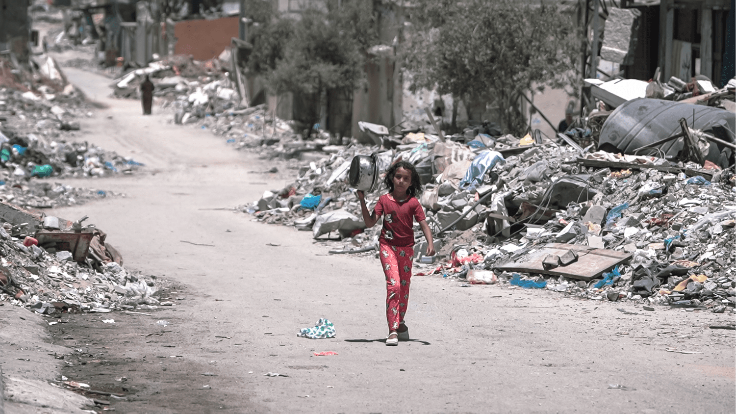 a young girl walks inside a destroyed Gaza during the Israel war to get food