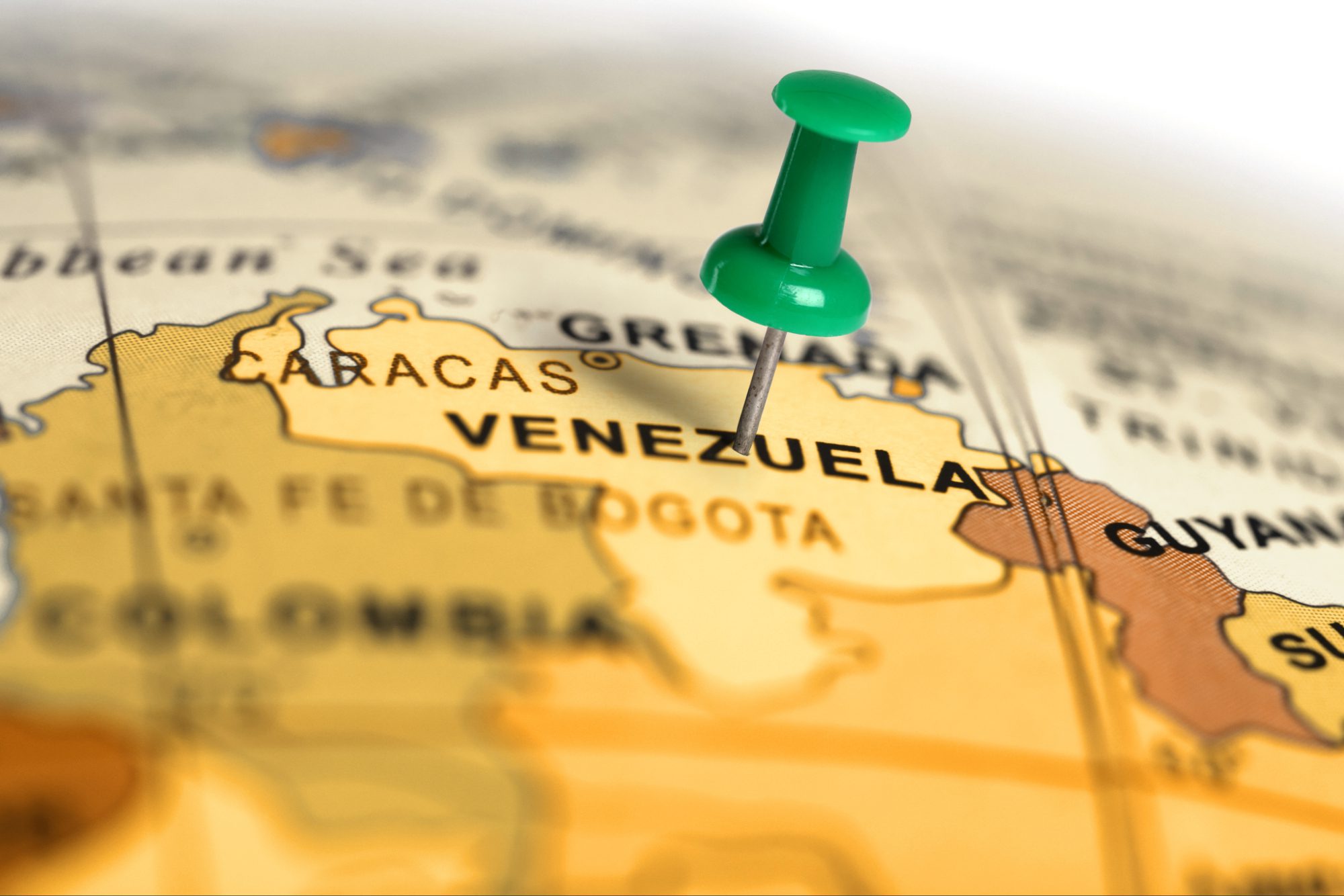 close up of a map with a green pin in Venezuela