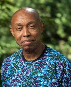 photo head shot of man in colorful shirt