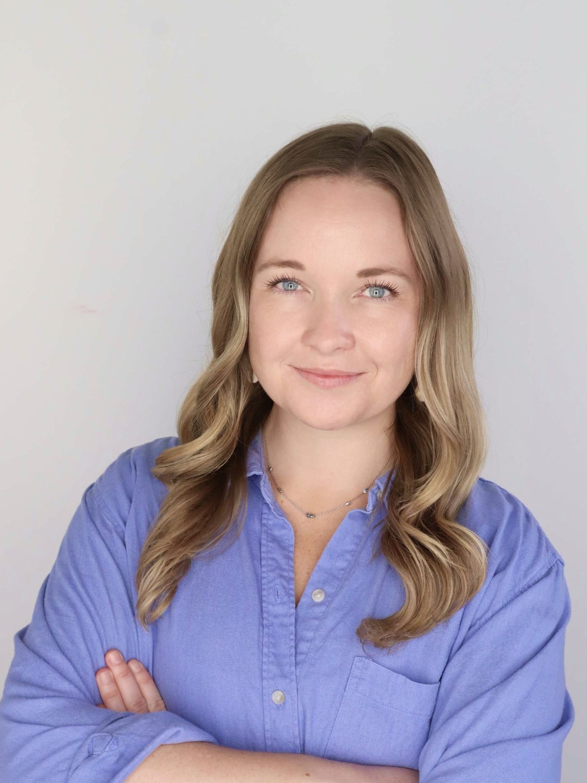 headshot of blonde woman in blue shirt