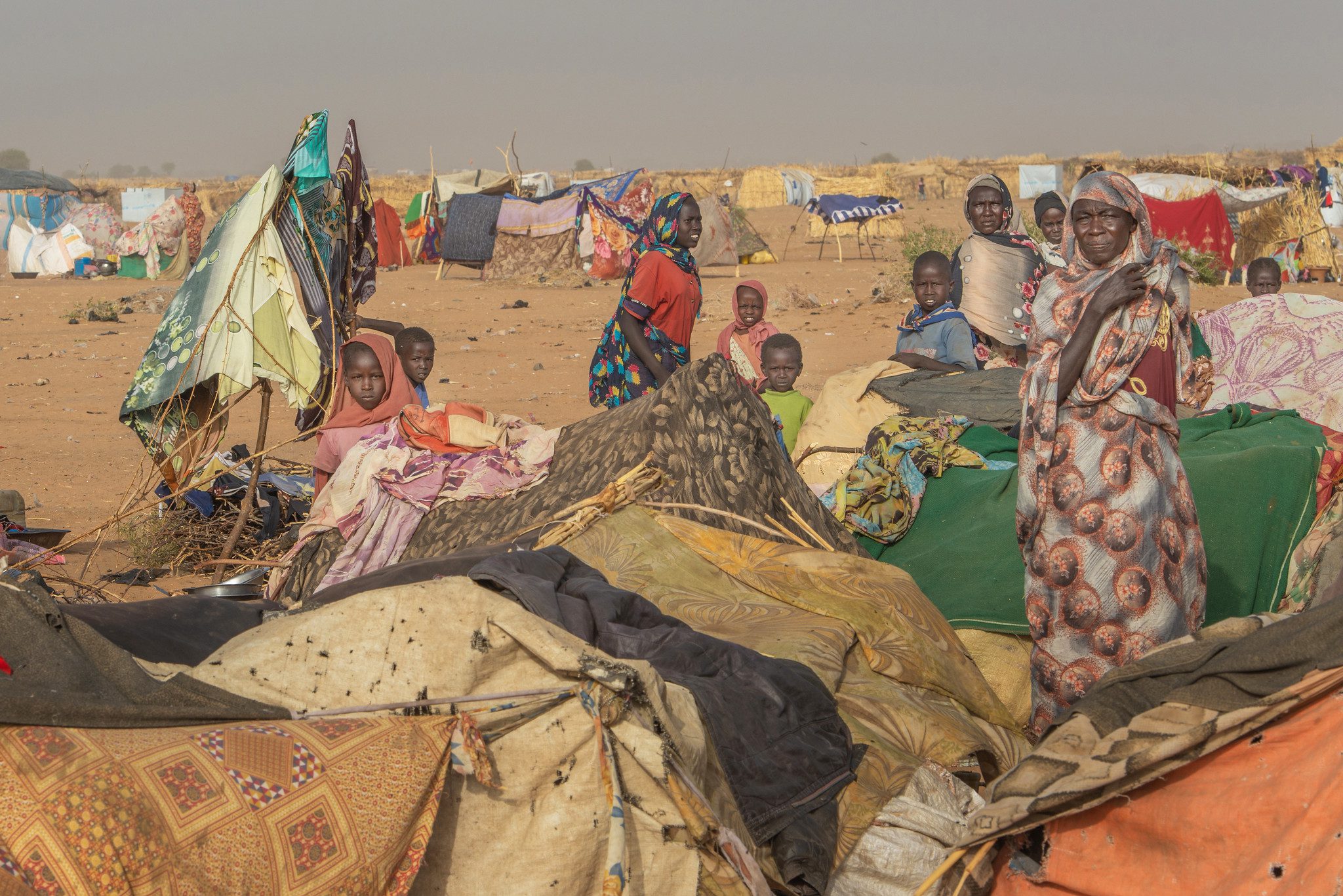 The road west toward the town of Tawila was crowded with families escaping on foot and by donkey cart, some stopping at a crowded makeshift camp in an arid, sandy landscape, with shelters built from patched-together cloth, blankets, tarpaulins and branches.