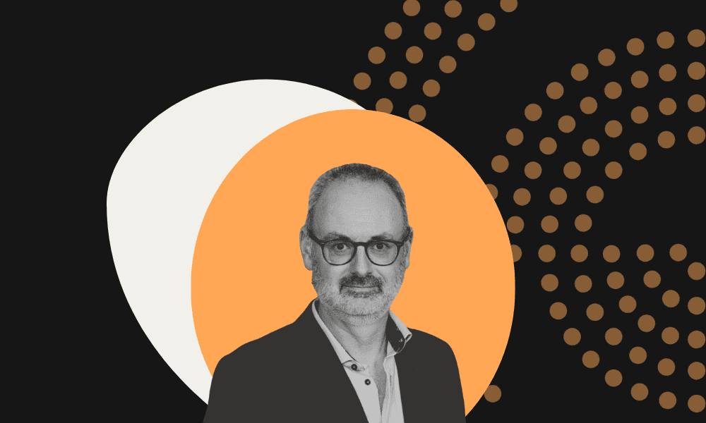 headshot of interviewee on black and orange background