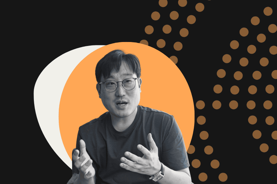 man in tshirt against decorative orange and black background. interview with Dong Jin Kim banner