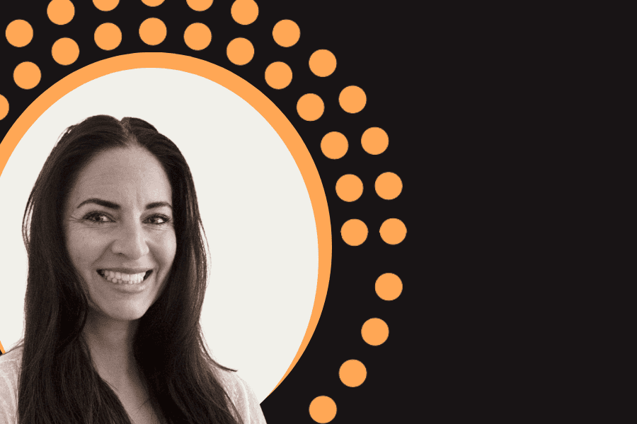 headshot woman with long dark hair against white, orange and black decorative background